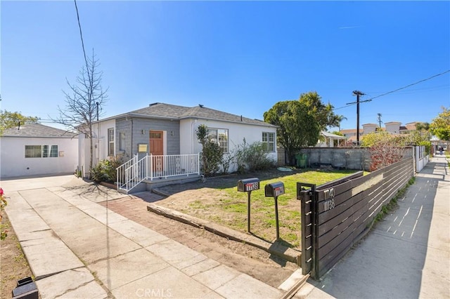 ranch-style house with a front yard and fence