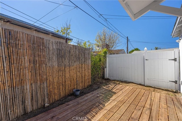 wooden terrace featuring fence