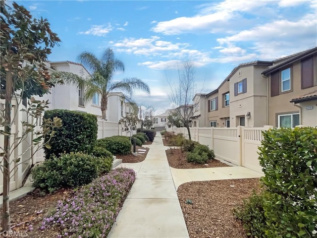 view of property's community with fence and a residential view