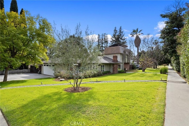 view of front of house with a garage, driveway, and a front lawn