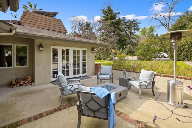 view of patio / terrace with french doors and a fire pit