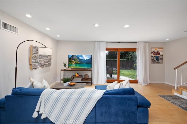 living area with stairway, visible vents, baseboards, recessed lighting, and light wood-style floors