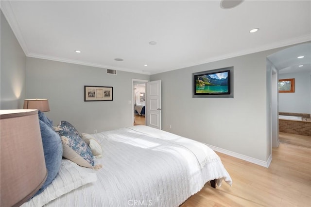 bedroom with recessed lighting, light wood-style flooring, crown molding, and baseboards