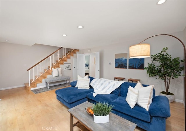 living room featuring recessed lighting, stairway, baseboards, and wood finished floors
