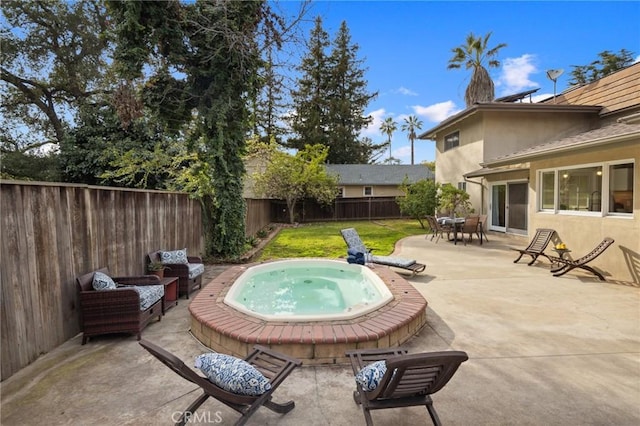 view of patio with a fenced backyard and an outdoor hot tub