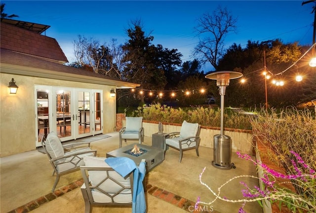 view of patio with french doors and an outdoor fire pit