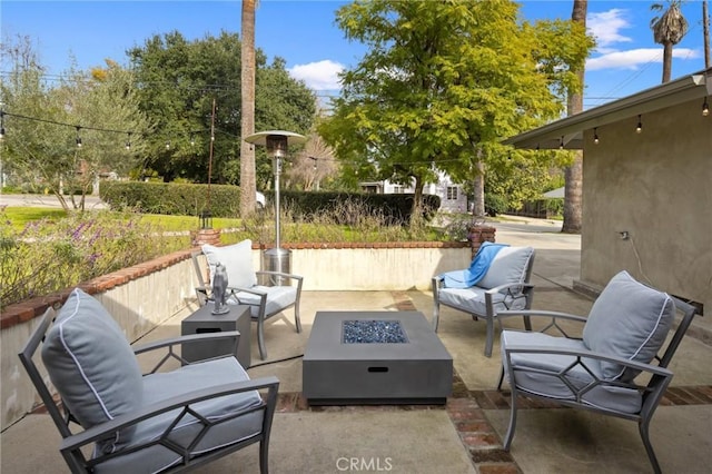 view of patio / terrace featuring an outdoor living space with a fire pit