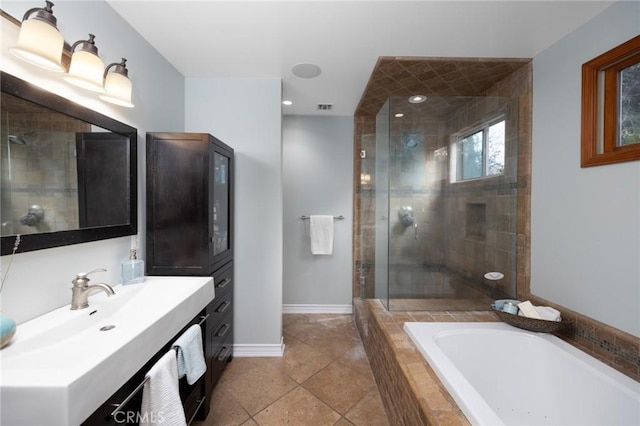 bathroom with vanity, baseboards, visible vents, a shower stall, and a garden tub