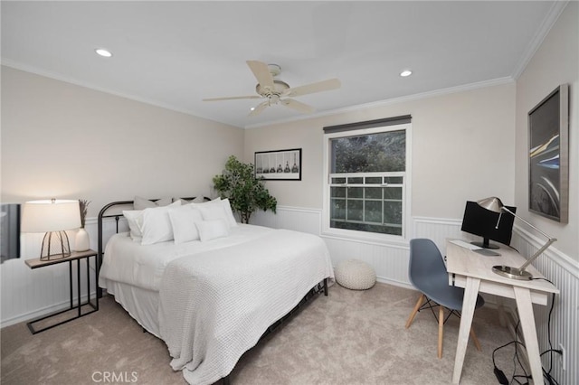 carpeted bedroom with ceiling fan, crown molding, recessed lighting, and wainscoting