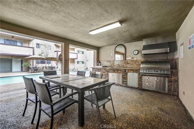 dining space with dark carpet and a textured ceiling