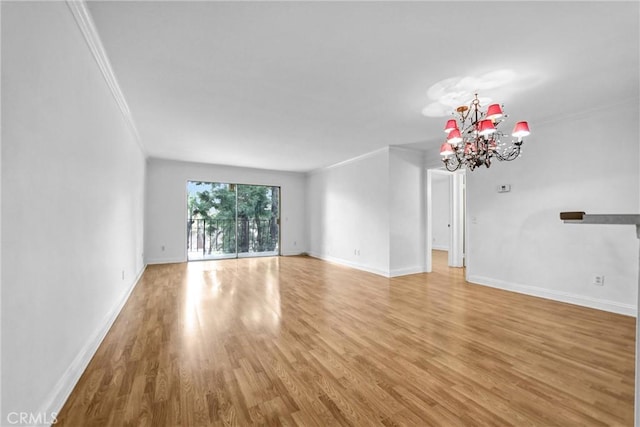 unfurnished living room with light wood finished floors, baseboards, an inviting chandelier, and ornamental molding