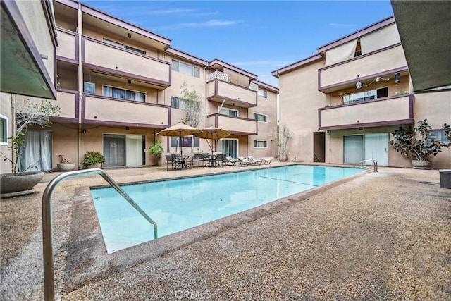 community pool with a patio area