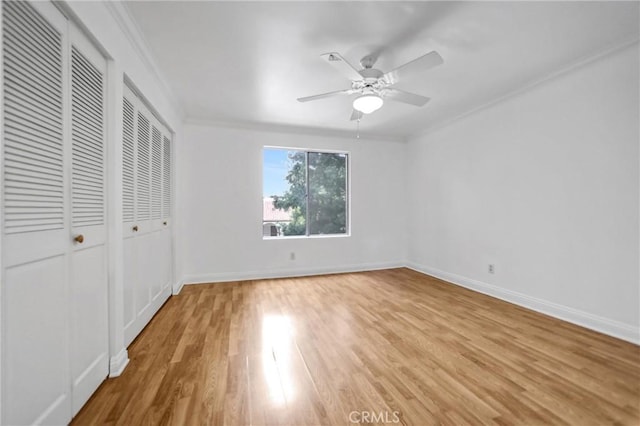 unfurnished bedroom with a closet, baseboards, light wood finished floors, and ornamental molding