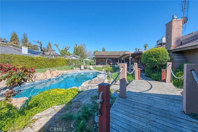 view of pool with a deck and a fenced in pool