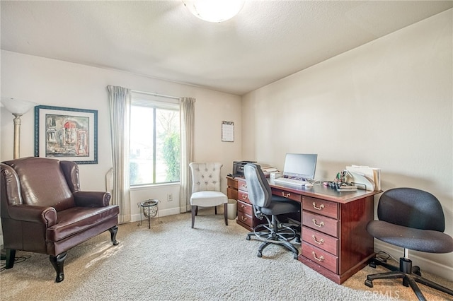 office area featuring light colored carpet, a textured ceiling, and baseboards