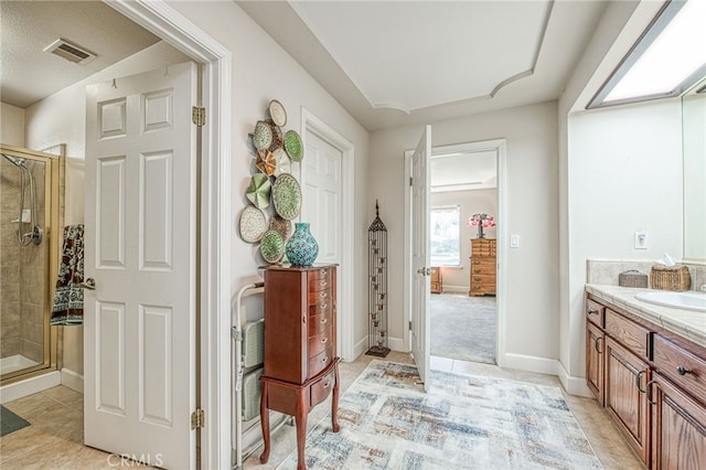 full bath with vanity, a shower stall, visible vents, and tile patterned floors