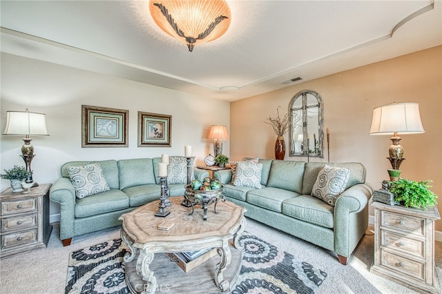 living room with visible vents and carpet