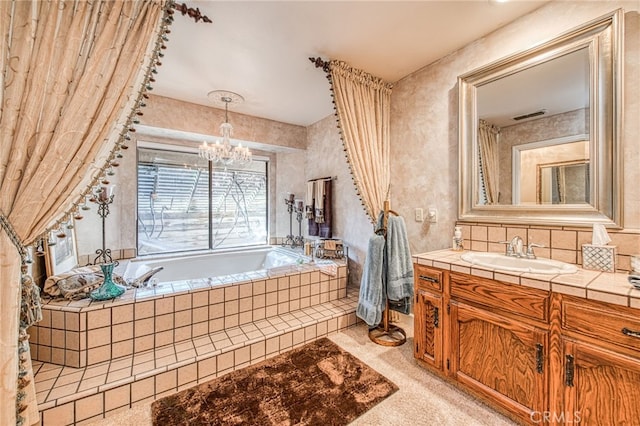 bathroom with visible vents, backsplash, a chandelier, a garden tub, and vanity