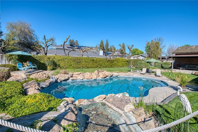 view of pool with a patio area, a fenced in pool, and fence