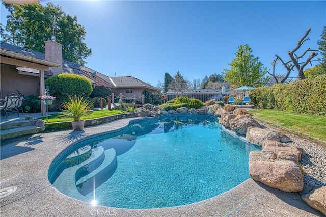 view of swimming pool with a fenced in pool and fence