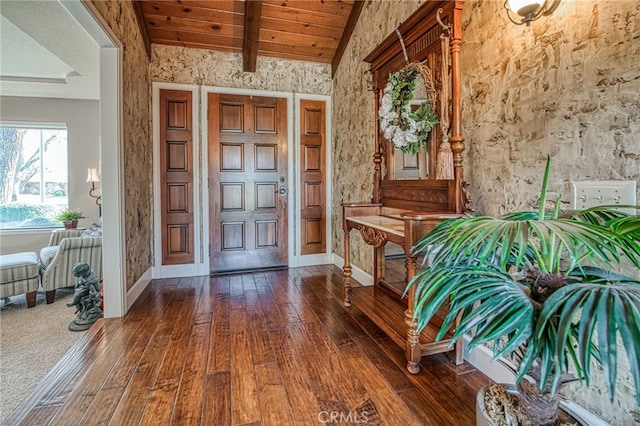 foyer featuring hardwood / wood-style floors, lofted ceiling with beams, baseboards, and wooden ceiling