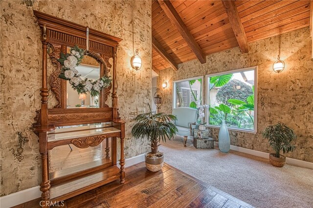 sitting room with baseboards, high vaulted ceiling, wood-type flooring, wooden ceiling, and beamed ceiling