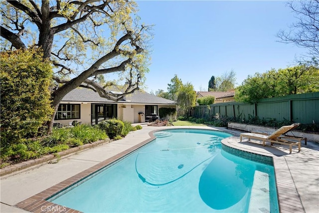 view of pool with a fenced in pool, a patio, and a fenced backyard