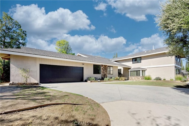 view of front facade featuring concrete driveway and a garage