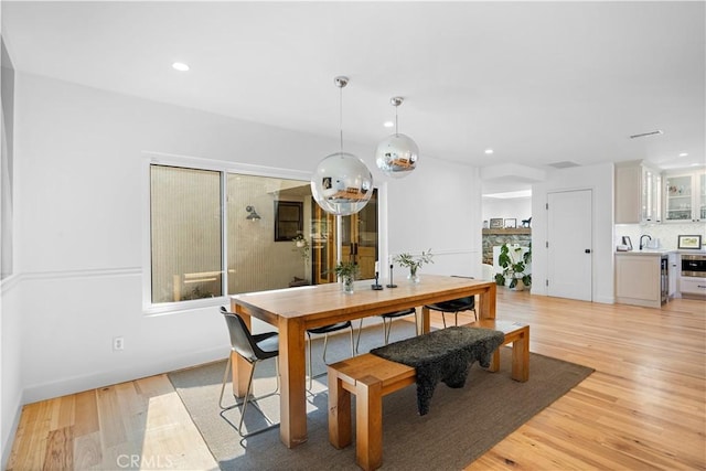 dining area with light wood-style flooring and recessed lighting