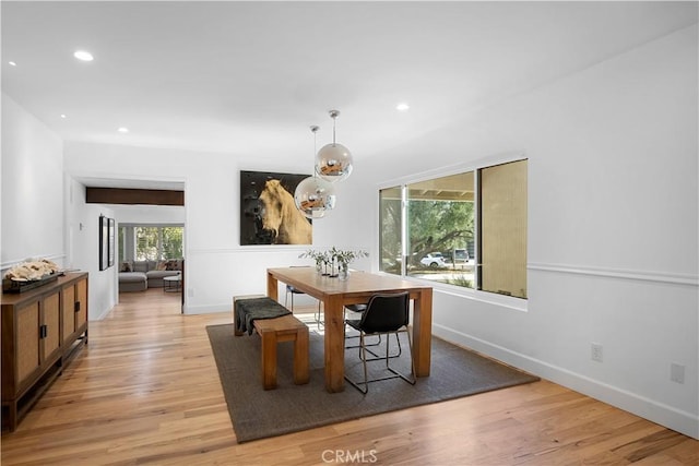 dining room featuring recessed lighting, a notable chandelier, baseboards, and light wood-style floors