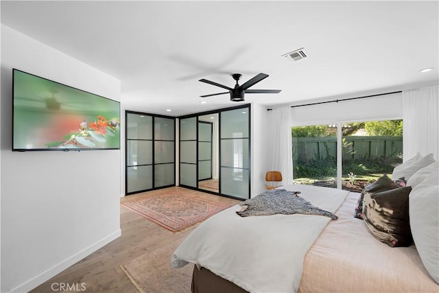 bedroom featuring visible vents, a ceiling fan, wood finished floors, recessed lighting, and baseboards