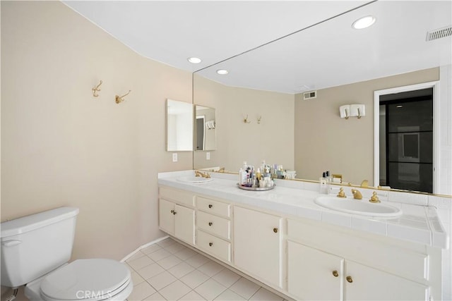 bathroom with tile patterned floors, visible vents, toilet, and a sink