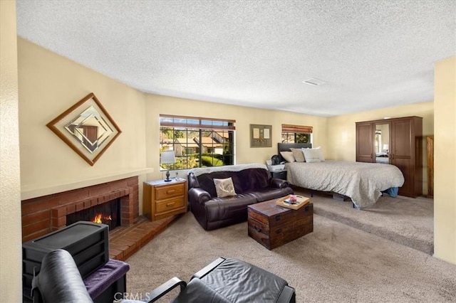 carpeted bedroom featuring a brick fireplace and a textured ceiling