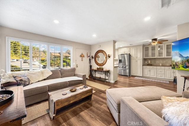 living area with recessed lighting, wood finished floors, visible vents, and ceiling fan