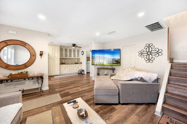 living room with visible vents, stairs, recessed lighting, wood finished floors, and a ceiling fan