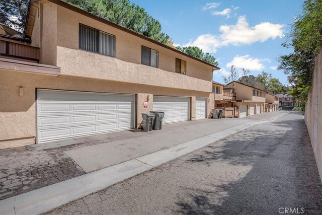 view of front of property with a garage and stucco siding