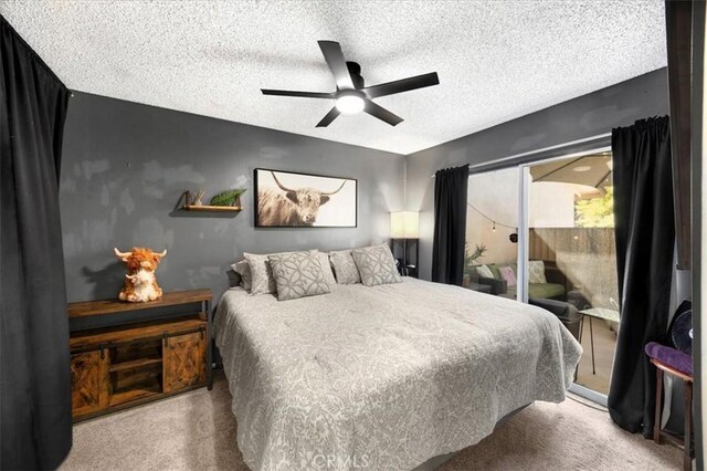 carpeted bedroom featuring access to exterior, a textured ceiling, and a ceiling fan