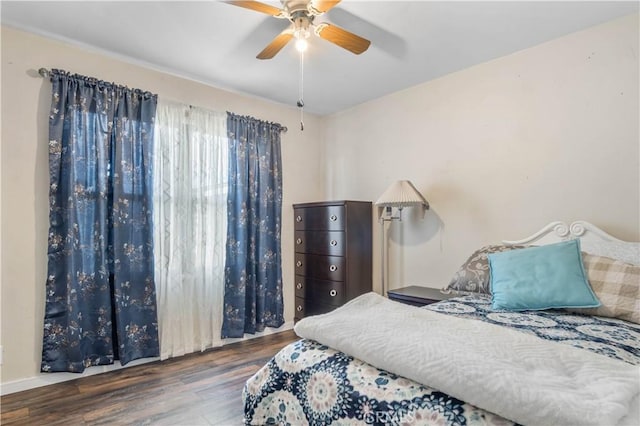 bedroom featuring a ceiling fan and wood finished floors