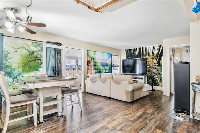 living room featuring dark wood finished floors and a ceiling fan