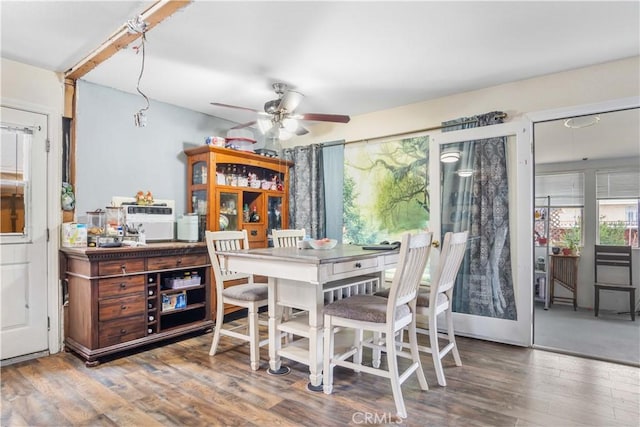 dining area featuring a ceiling fan and wood finished floors