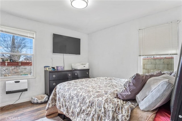 bedroom with baseboards and wood finished floors