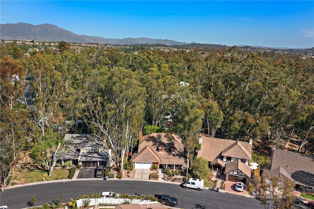 drone / aerial view featuring a forest view and a mountain view