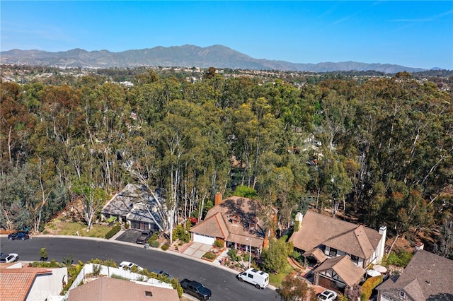 birds eye view of property with a view of trees and a mountain view