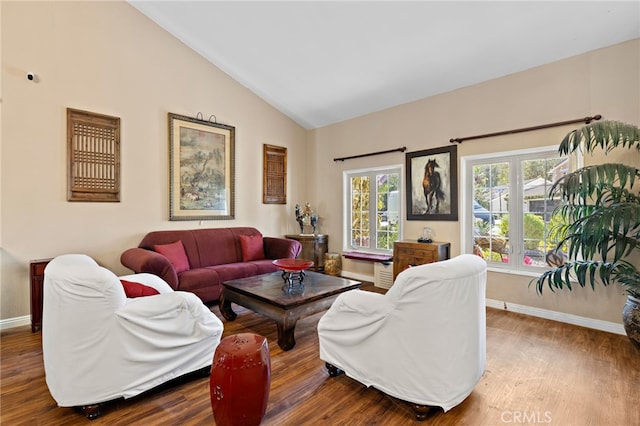 living room with baseboards, lofted ceiling, and wood finished floors