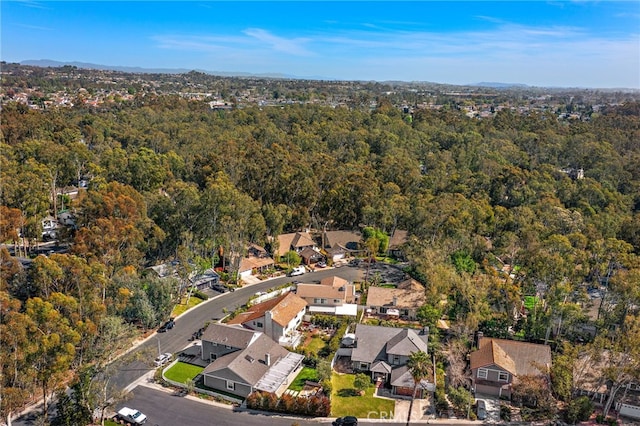 birds eye view of property featuring a view of trees and a residential view