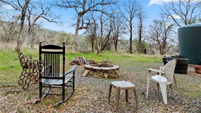 view of yard featuring an outdoor fire pit