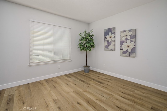 unfurnished room featuring light wood-style flooring and baseboards