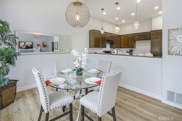 dining area with visible vents, baseboards, recessed lighting, a high ceiling, and light wood-style floors