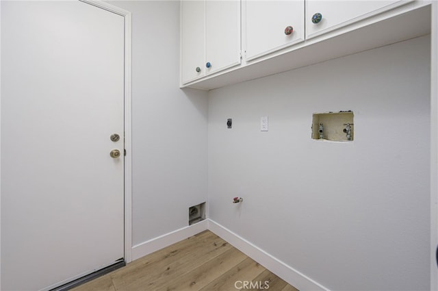 clothes washing area with washer hookup, cabinet space, light wood finished floors, baseboards, and hookup for an electric dryer