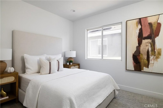 carpeted bedroom featuring baseboards